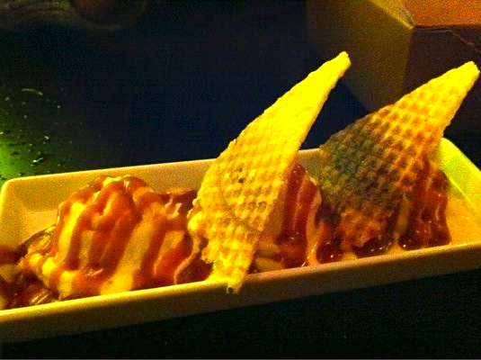 Olive oil ice cream with sea salt caramel and warm waffle cone triangles