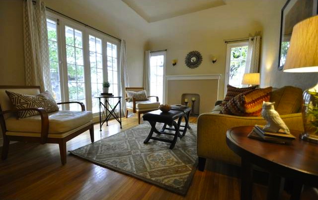 Living room with original windows, wood floors and soffitted ceilng
